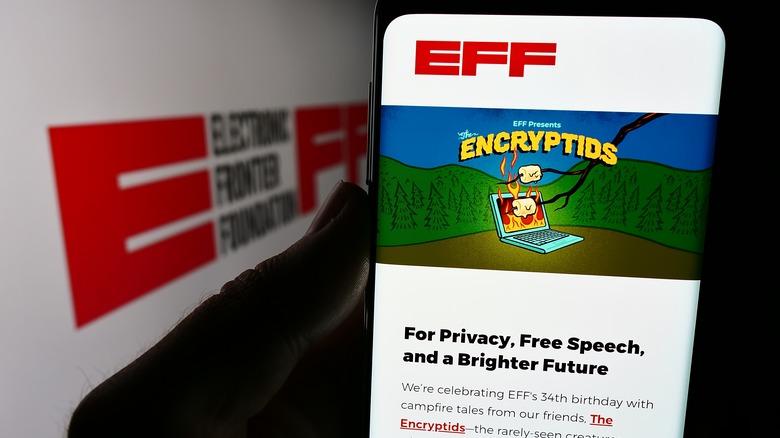 EFF mobile website on phone with out of focus logo in background