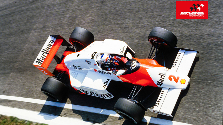 An F1 car racing on the road with the 1981 McLaren logo in the top corner