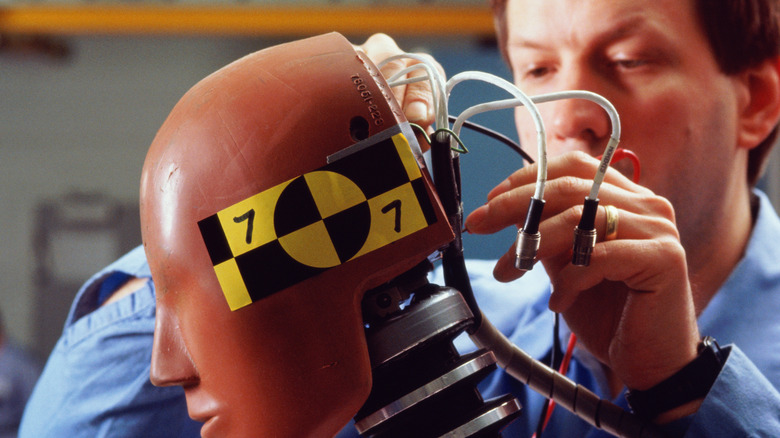 Man preparing crash test dummy