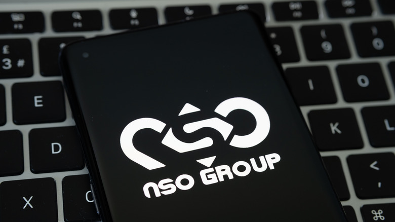 A smartphone display showing NSO Group logo 