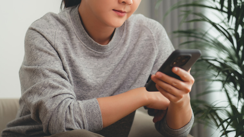 woman looking at an iphone