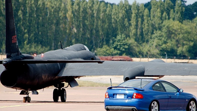 U-2 chase car with airplane on runway