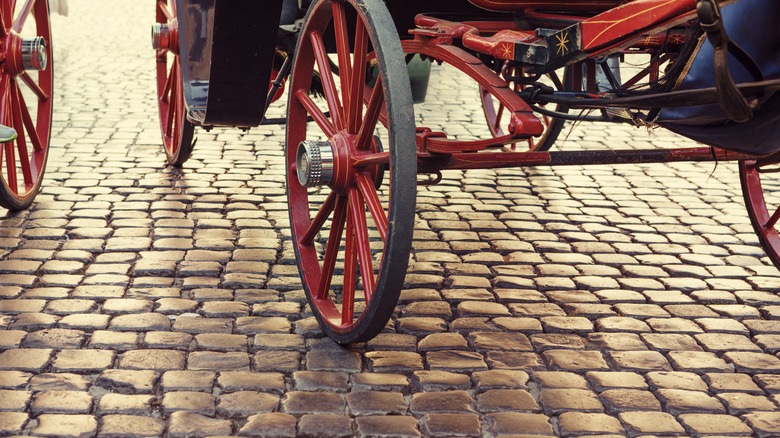 Horse drawn carriage on cobblestone road