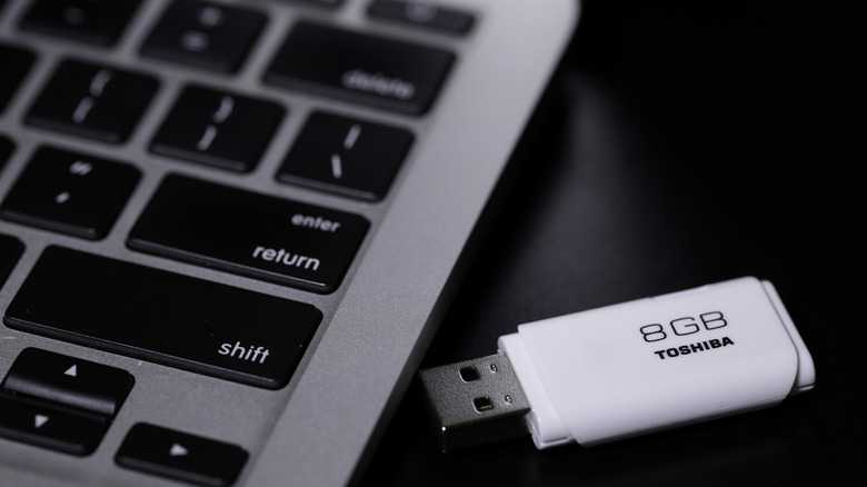 flash drive beside a Mac