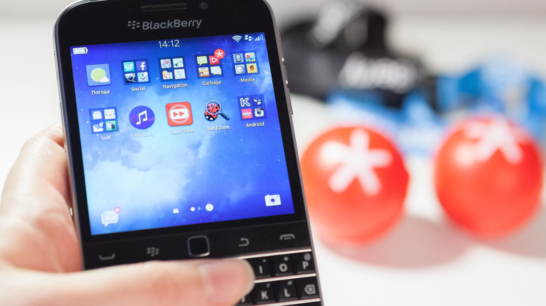 woman holding BlackBerry classic