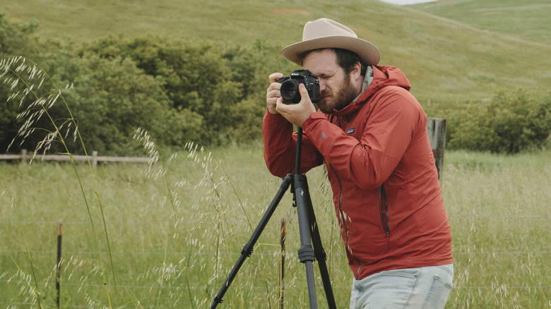 man using carbon fiber tripod