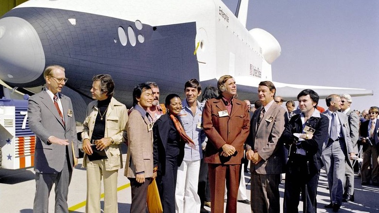 Gene Roddenberry and the cast of Star Trek stand in front of the Space Shuttle Enterprise
