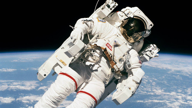 Astronaut Bruce McCandless floats away from the space shuttle using the Manned Maneuvering Unit (MMU)