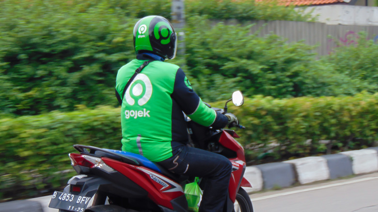 man Gojek uniform riding motorcycle