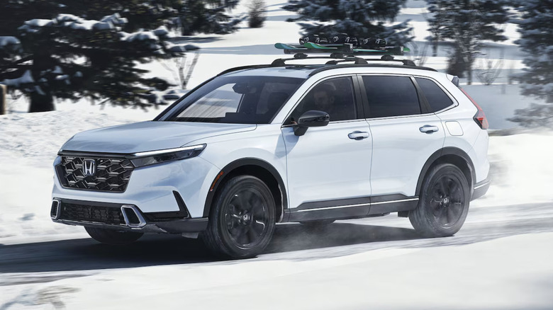 A white Honda CR-V driving in the snow