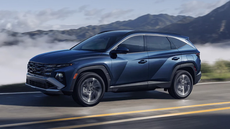 A blue Hyundai Tucson driving along a mountain road