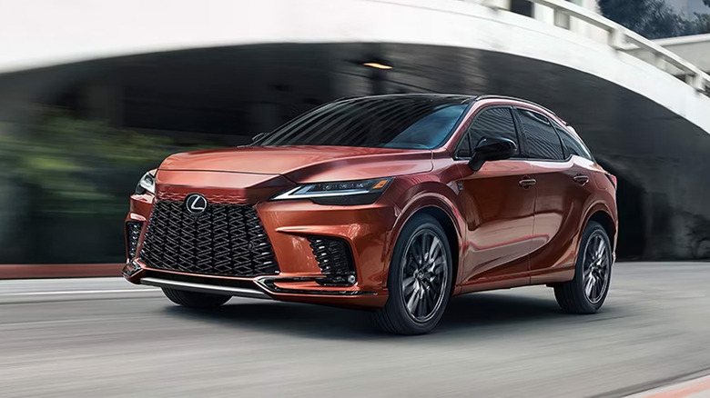 An orange Lexus RX 350 driving on a city road