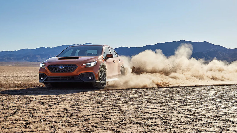 An orange Subaru WRX doing donuts in the desert