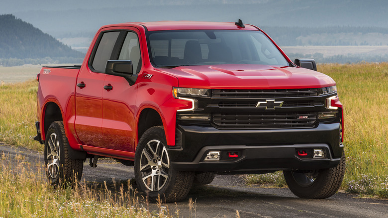 Red 2019 Chevrolet Silverado LT Trail Boss parked on dirt road