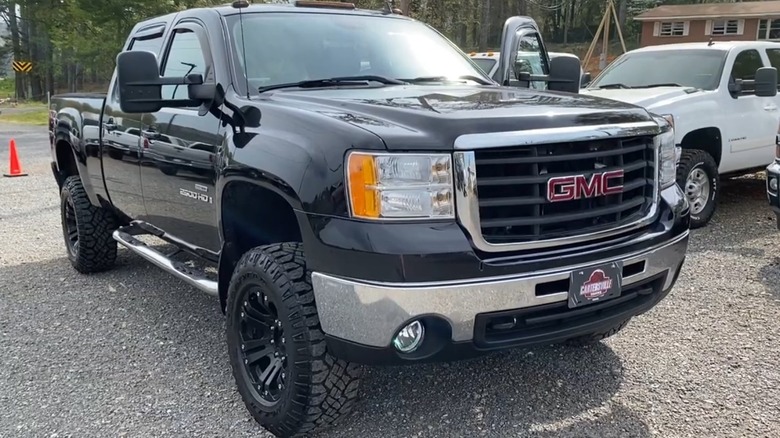 Black 2008 GMC Sierra HD parked on gravel