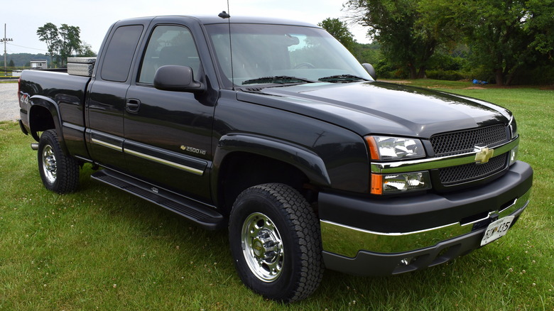 Black 2002 Chevrolet Silverado 2500 HD parked on grass