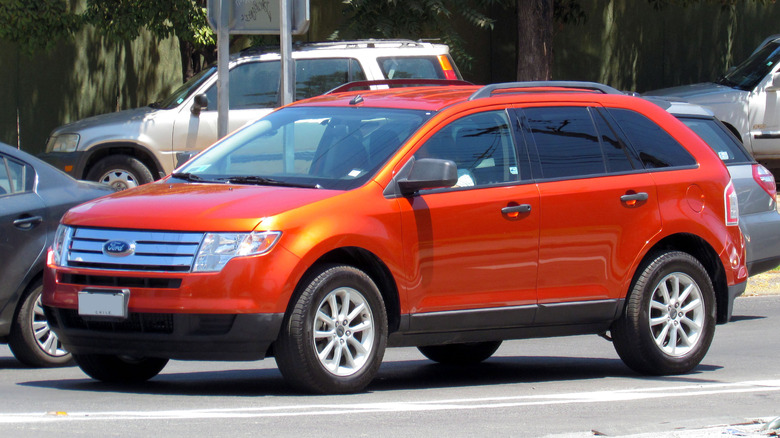 Orange 2009 Ford Edge SE AWD stopped at a traffic light