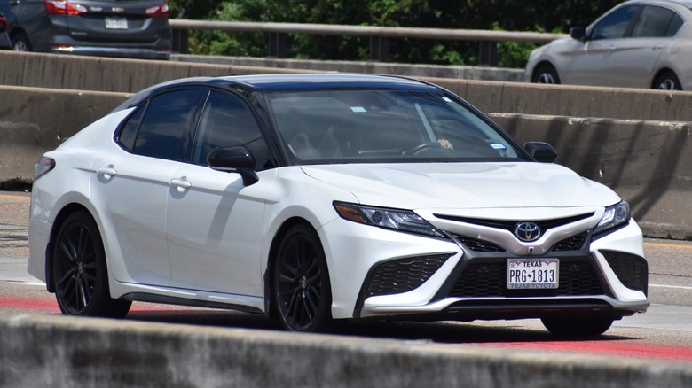 White Toyota Camry highway driving