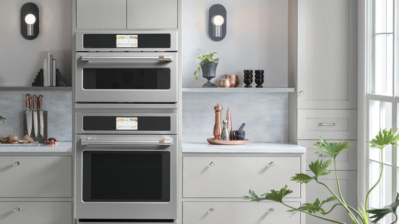 A Cafe Electric stainless-steel oven in a white kitchen