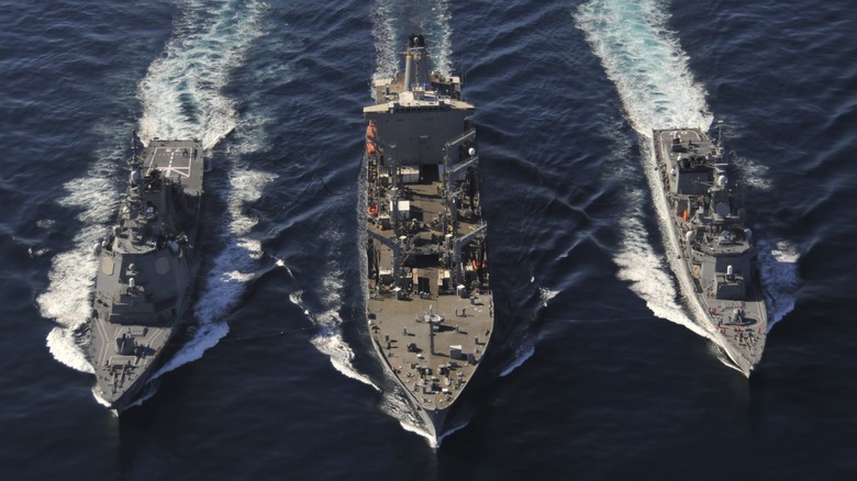 The U.S. Military Sealift Command resupplying two U.S. Navy ships.