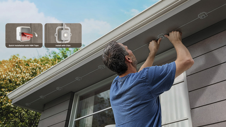 person putting up Govee Outdoor Lights