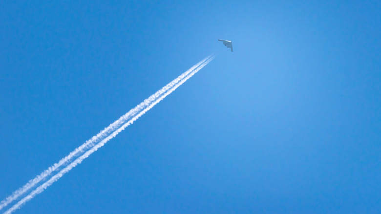 stealth bomber with contrail