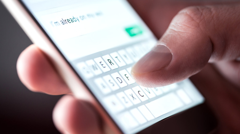 someone using the on-screen keyboard on a smartphone