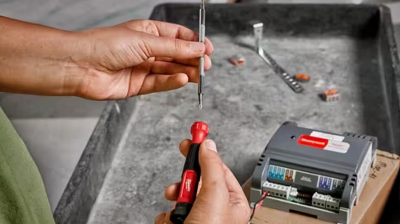 Man removing screwdriver shaft