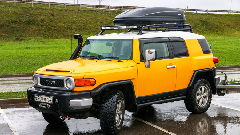 a yellow FJ Cruiser in an open parking