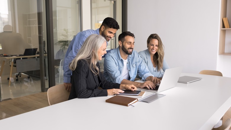 Group of people watching laptop