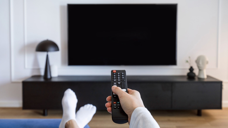 TV on a wall with remote control