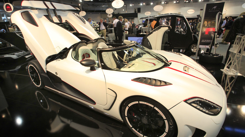 White Koenigsegg Agera spreading its panels in exhibit