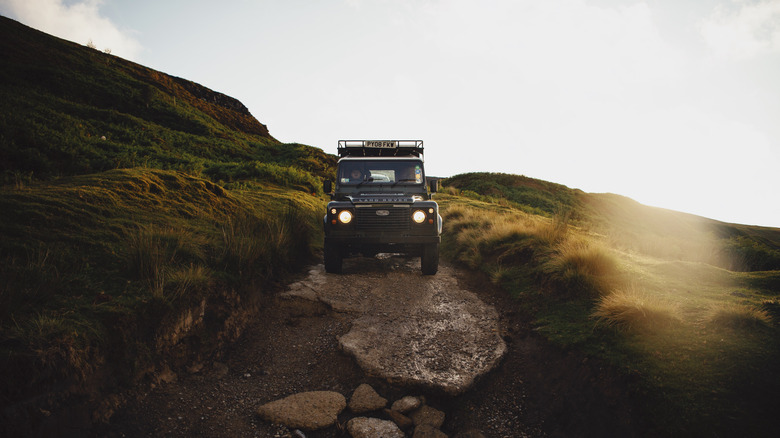 Land Rover Defender in rugged terrain 