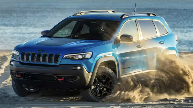 blue Jeep Cherokee on beach