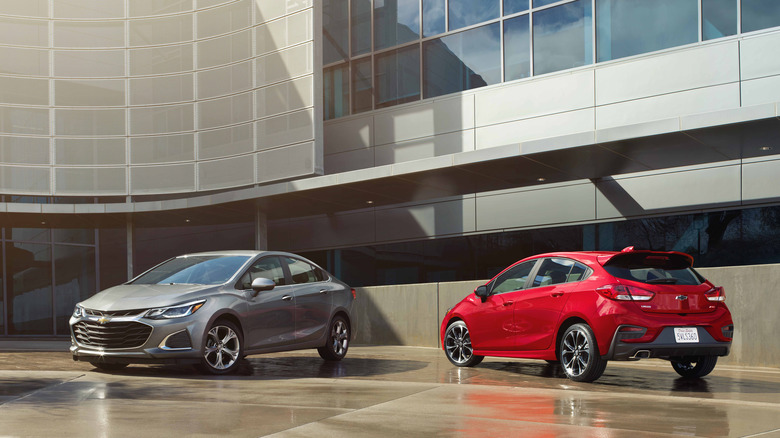 Chevrolet Cruze and Cruze Hatchback in front of building