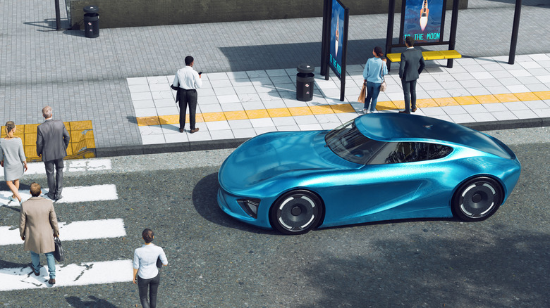 blue electric car at crosswalk