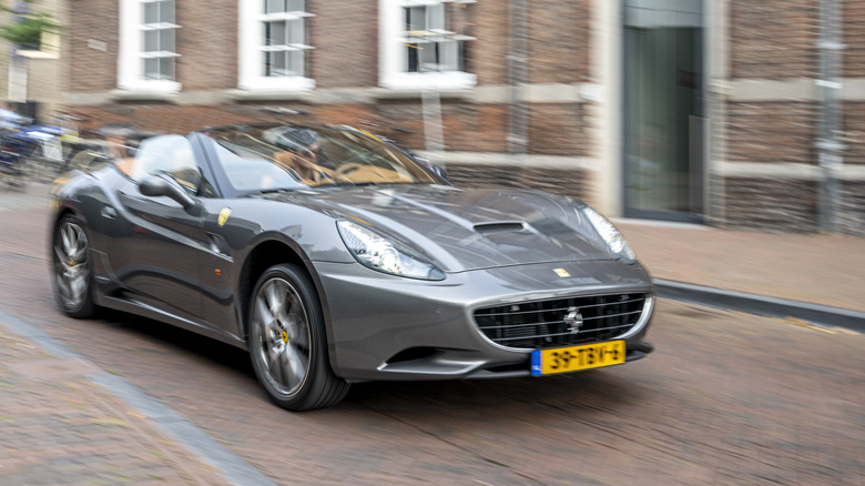 Ferrari California driving down a road