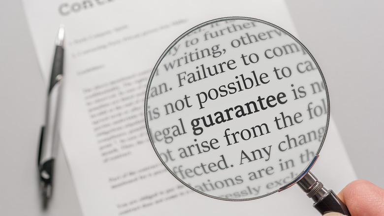 Magnifying glass showing fine print of contract