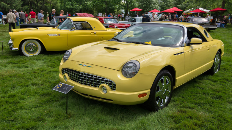 two yellow Thunderbirds at car show