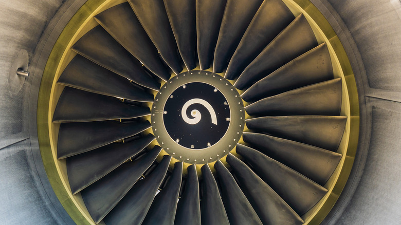 close-up of a jet engine intake fan, with a spiral painted on