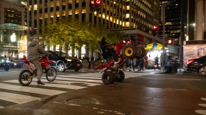 People riding dirt bikes and ATVs down Fifth Avenue in NYC