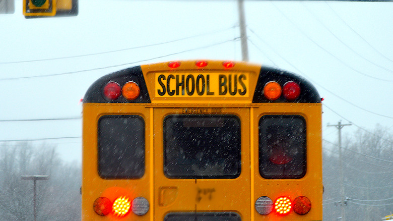 School bus sign atop a yellow vehicle.