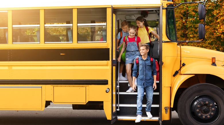 Children stepping out of a school bus