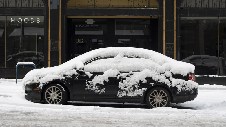 snow covered sedan city street