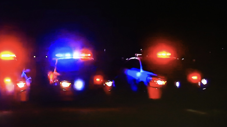 Three parked police cars with their lights on