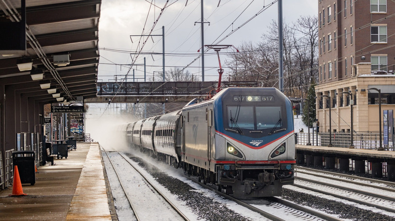 An Amtrak train pulls into a snowy station