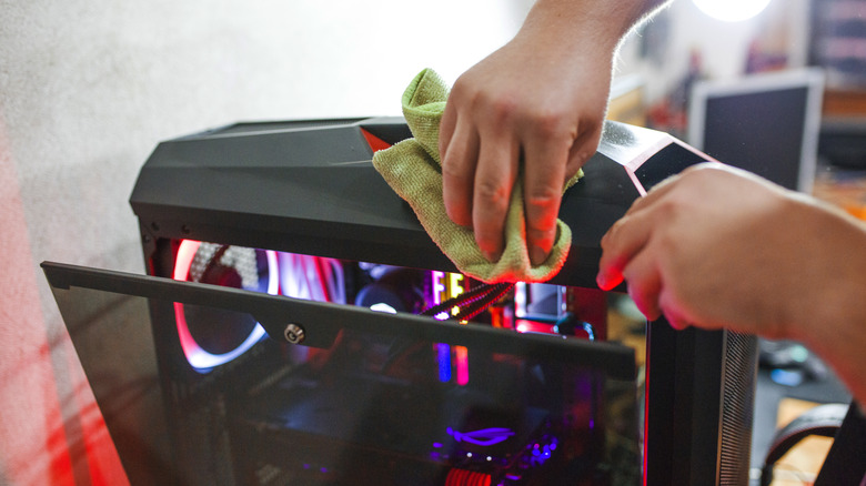 Person cleaning computer case