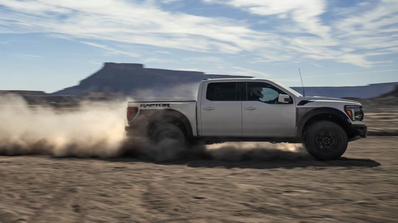 White Ford F-150 Raptor on sand