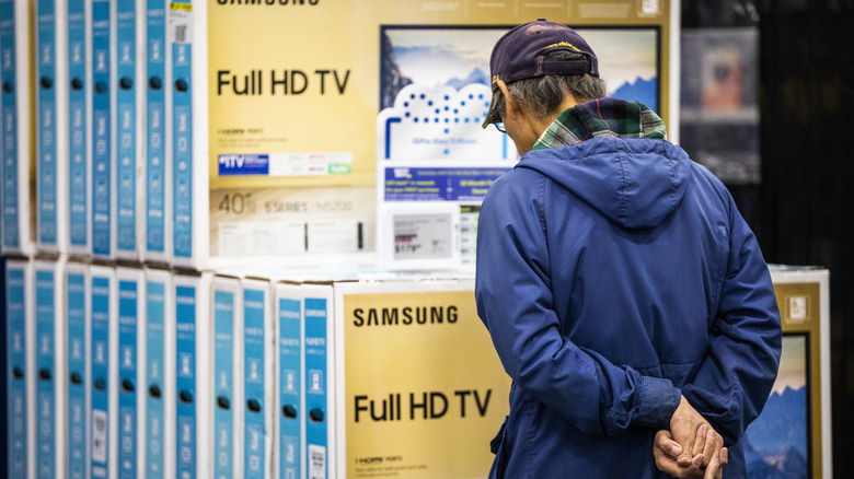 Customer looks at TVs on sale