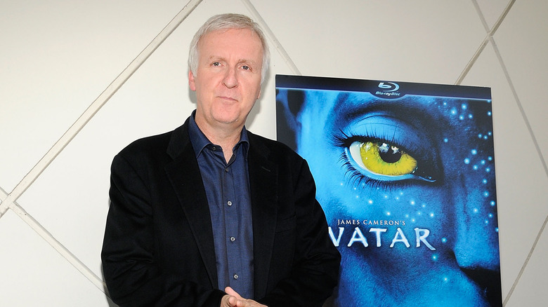 James Cameron with Avatar poster